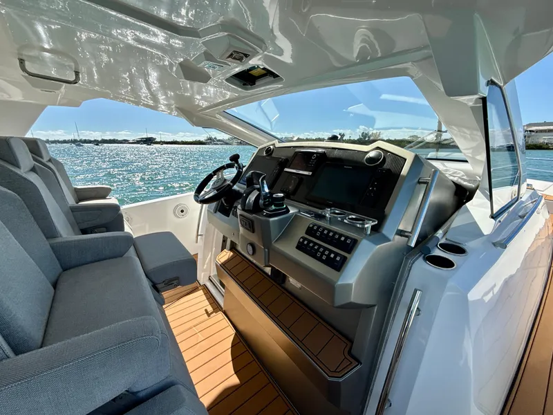 Slide: The Image of 2019 Azimut 40 Verve yacht interior with modern helm and seating, overlooking the ocean. - 16
