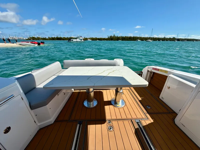 Slide: The Image of Azimut 40 Verve 2019 yacht deck with table, overlooking serene blue waters. - 17