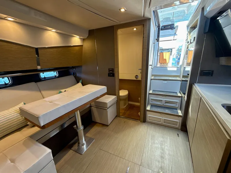 Slide: The Image of Luxurious interior of 2019 Azimut 40 Verve yacht, featuring modern seating and compact bathroom. - 2
