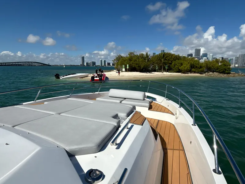 Slide: The Image of Azimut 40 Verve 2019 yacht near tropical island with city skyline in background. - 22