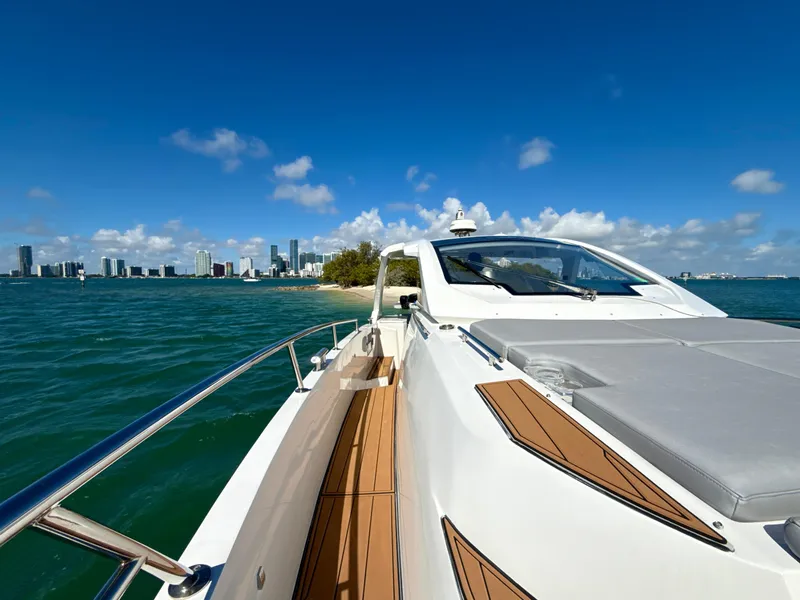 Slide: The Image of Azimut 40 Verve 2019 yacht cruising near a city skyline under a clear blue sky. - 24