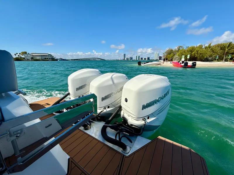 Slide: The Image of Azimut 40 Verve 2019 with Mercury engines, cruising near a scenic beach and city skyline. - 28