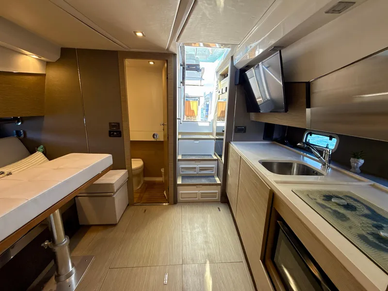 Slide: The Image of Interior of 2019 Azimut 40 Verve yacht, featuring modern kitchen and seating area. - 4