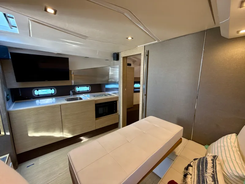 Slide: The Image of Interior of 2019 Azimut 40 Verve yacht, featuring modern kitchen and seating area. - 5