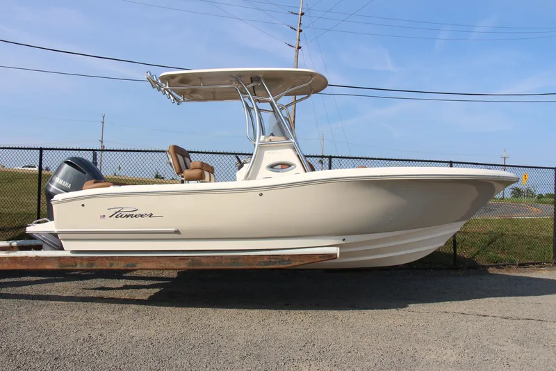 Slide: The Image of 2025 Pioneer 222 Islander boat with Yamaha engine, parked on a trailer, side view. - 10