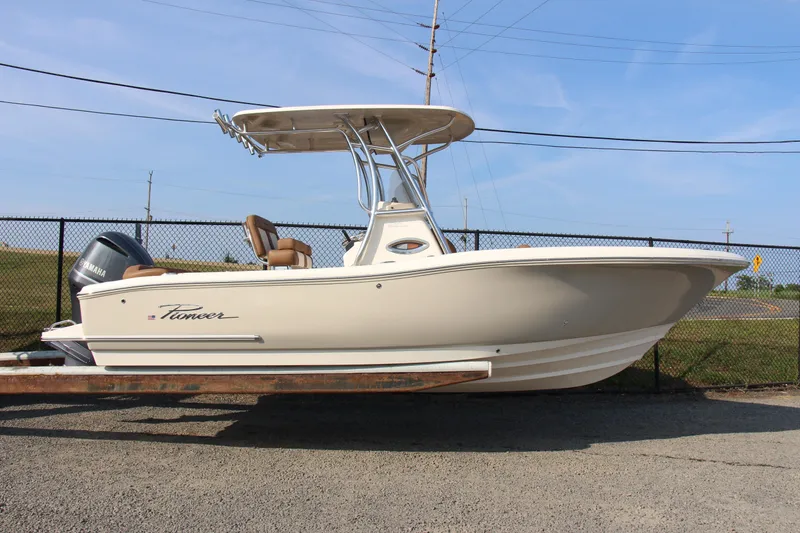 Slide: The Image of 2025 Pioneer 222 Islander boat with Yamaha engine, parked on a trailer. - 11