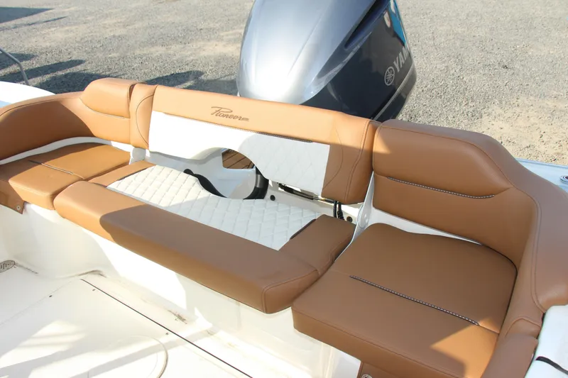 Slide: The Image of 2025 Pioneer 222 Islander boat with tan leather seating and Yamaha engine. - 13