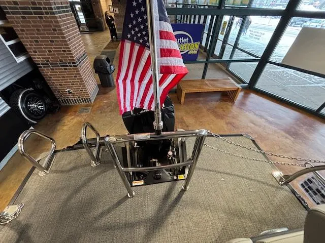 Slide: The Image of Barletta Cabrio 22M pontoon boat interior with American flag, showroom display, 2025 model. - 12