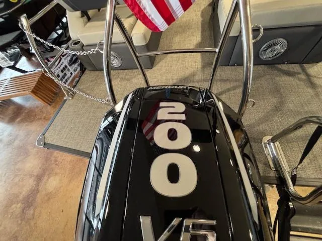 Slide: The Image of 2025 Barletta Cabrio 22M with Mercury 200 V6 engine, American flag in background. - 14