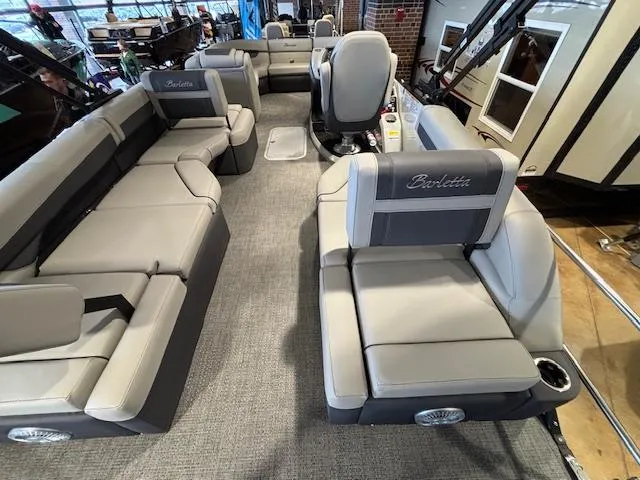 Slide: The Image of 2025 Barletta Cabrio 22M pontoon boat interior with luxurious seating and modern design. - 16