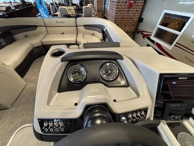 Slide: The Image of 2025 Barletta Cabrio 22M boat interior with modern dashboard and spacious seating. - 23