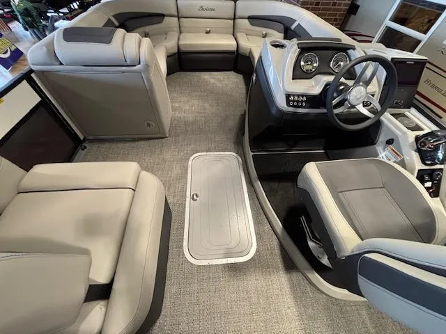 Slide: The Image of Interior of 2025 Barletta Cabrio 22M pontoon boat with plush seating and modern dashboard. - 24