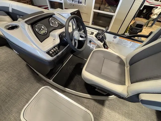 Slide: The Image of 2025 Barletta Cabrio 22M boat interior with steering wheel and dashboard controls. - 25