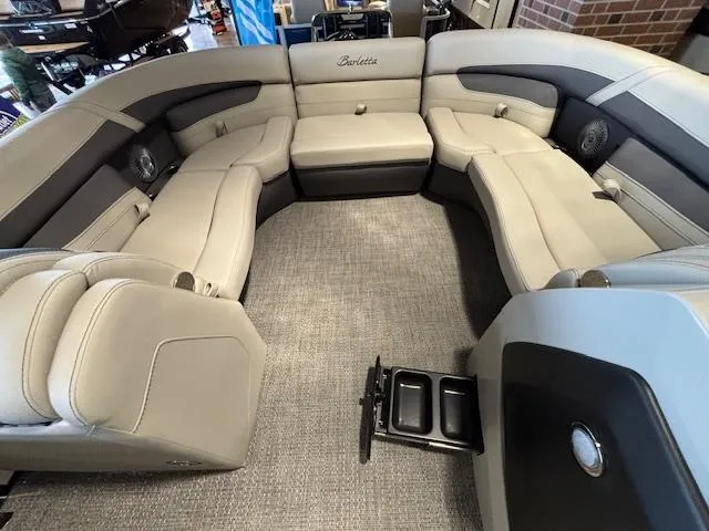 Slide: The Image of 2025 Barletta Cabrio 22M pontoon boat interior with luxurious seating and modern design. - 27