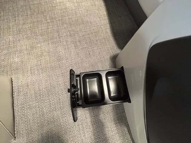 Slide: The Image of Barletta Cabrio 22M 2025 boat interior with dual cup holder on carpeted floor. - 28