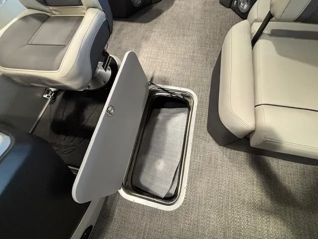Slide: The Image of Barletta Cabrio 22M 2025 boat interior with open storage compartment. - 7
