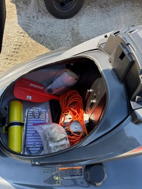 Slide: The Image of Open storage compartment of 2019 Yamaha WaveRunner SVHO with safety gear and equipment. - 10