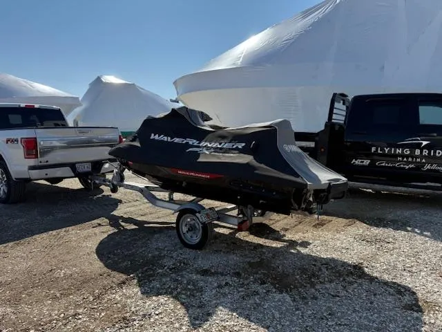 Slide: The Image of 2019 Yamaha WaveRunner SVHO on trailer, covered, parked between trucks. - 16