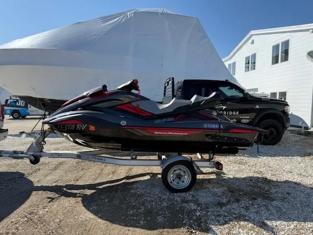 Slide: The Image of 2019 Yamaha WaveRunner SVHO on trailer, parked outdoors near a truck and building. - 19