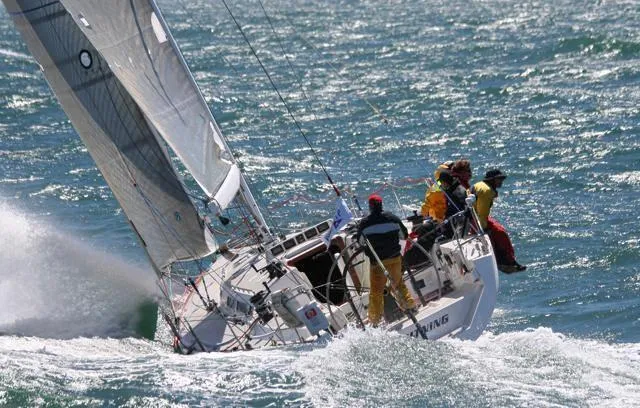 Slide: The Image of Sailing yacht Santa Cruz 52 from 1996 navigating rough seas with crew onboard. - 0