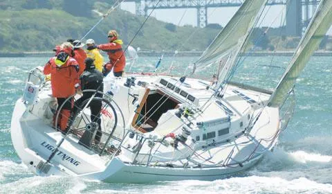Slide: The Image of Sailboat Santa Cruz 52, 1996 model, navigating choppy waters with crew onboard. - 1