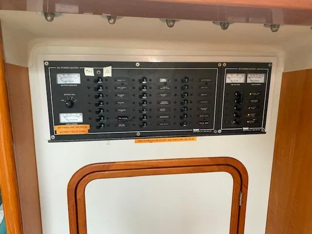 Slide: The Image of Electrical control panel on a 1996 Santa Cruz 52 yacht, featuring switches and gauges. - 13