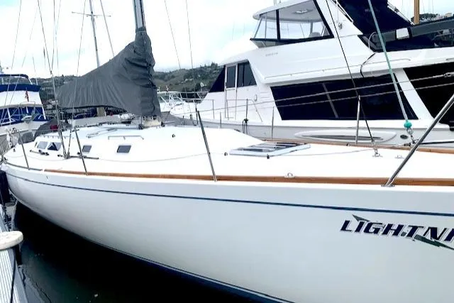 Slide: The Image of Sailboat docked in marina, Santa Cruz 52, 1996 model, named "LIGHTNING." - 2