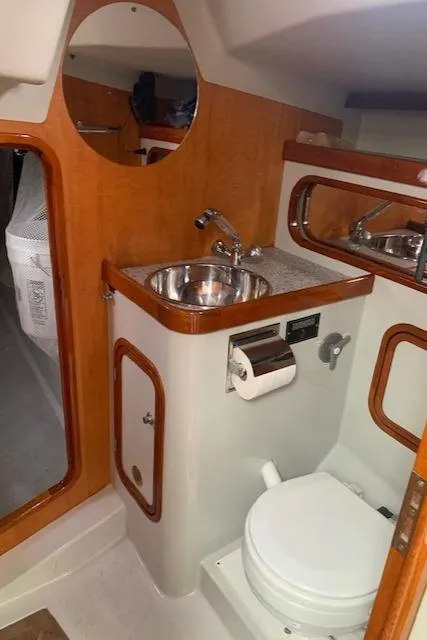 Slide: The Image of 1996 Santa Cruz 52 yacht bathroom with sink, toilet, and wooden accents. - 22
