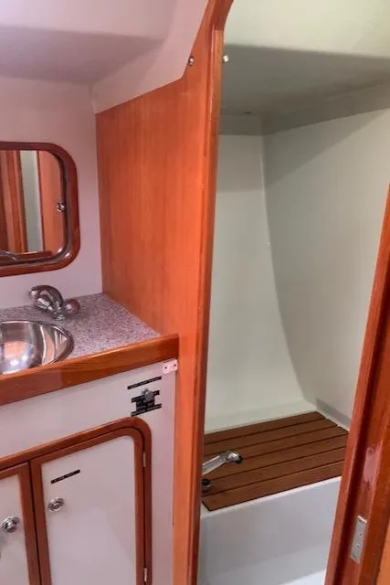 Slide: The Image of 1996 Santa Cruz 52 yacht bathroom with wooden accents and compact sink. - 25