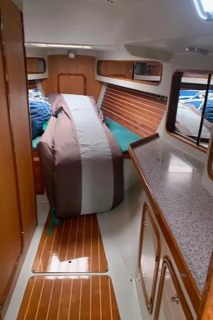 Slide: The Image of Interior of a 1996 Santa Cruz 52 sailboat with wood paneling and compact layout. - 35