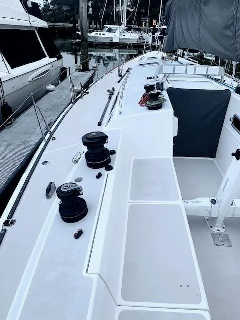 Slide: The Image of Sailboat deck of a 1996 Santa Cruz 52, docked with visible winches and rigging. - 6