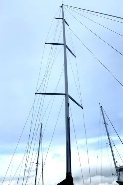 Slide: The Image of Tall sailboat mast against cloudy sky, Santa Cruz 52, 1996 model. - 9