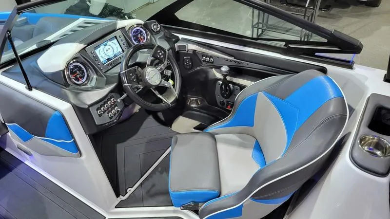 Slide: The Image of 2018 Supra SL 450 boat interior with blue and gray seating, modern dashboard, and steering wheel. - 12