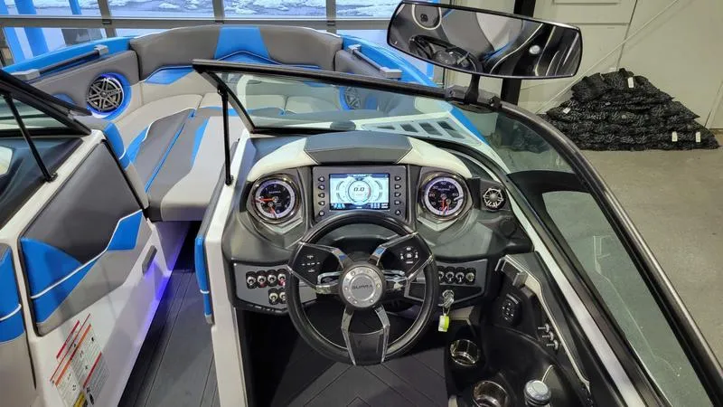 Slide: The Image of 2018 Supra SL 450 boat dashboard with modern controls and blue-accented seating. - 13