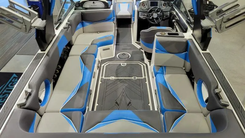 Slide: The Image of 2018 Supra SL 450 boat interior with blue and gray seating, modern design. - 8