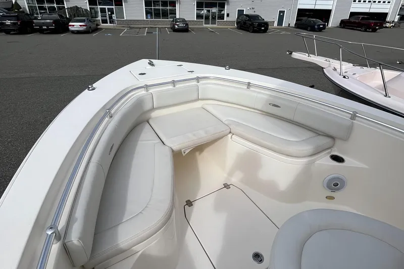 Slide: The Image of 2012 Cobia 237CC boat with spacious bow seating in a parking lot. - 10