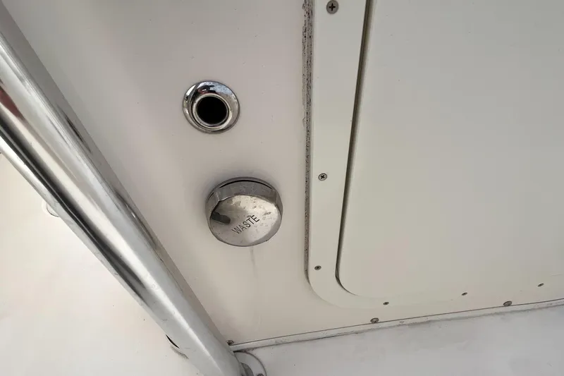 Slide: The Image of Close-up of a 2012 Cobia 237CC boat's water intake and waste outlet. - 11