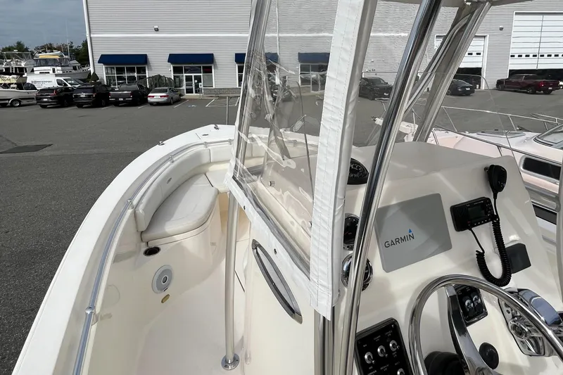 Slide: The Image of 2012 Cobia 237CC boat with Garmin navigation, docked near a building. - 12