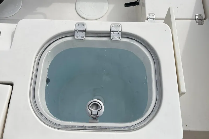 Slide: The Image of Livewell on a 2012 Cobia 237CC boat, filled with water. - 14