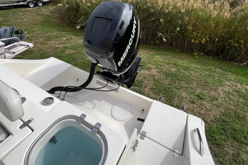Slide: The Image of 2012 Cobia 237CC boat with Mercury outboard motor, viewed from the rear deck. - 15