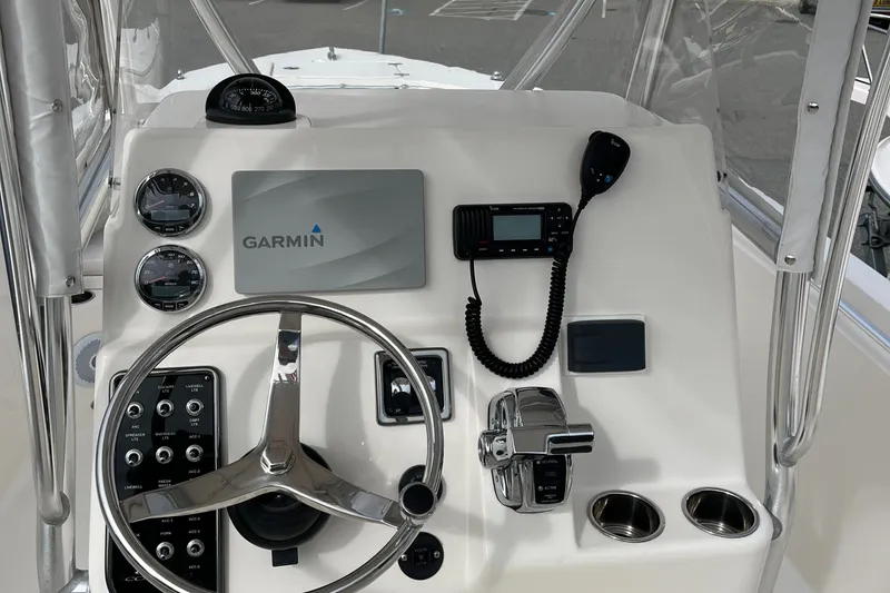 Slide: The Image of 2012 Cobia 237CC boat dashboard with Garmin navigation and control instruments. - 19