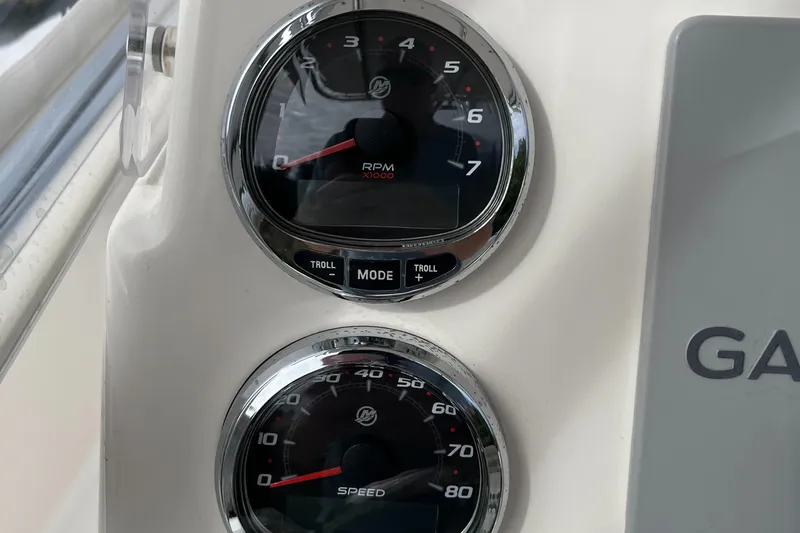 Slide: The Image of Close-up of 2012 Cobia 237CC boat gauges displaying RPM and speed. - 20