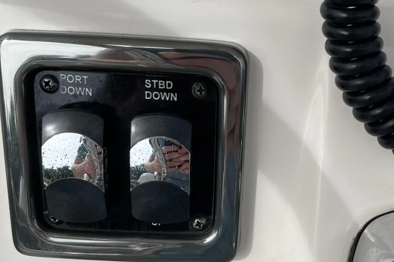 Slide: The Image of Control panel on a 2012 Cobia 237CC boat with port and starboard switches. - 22