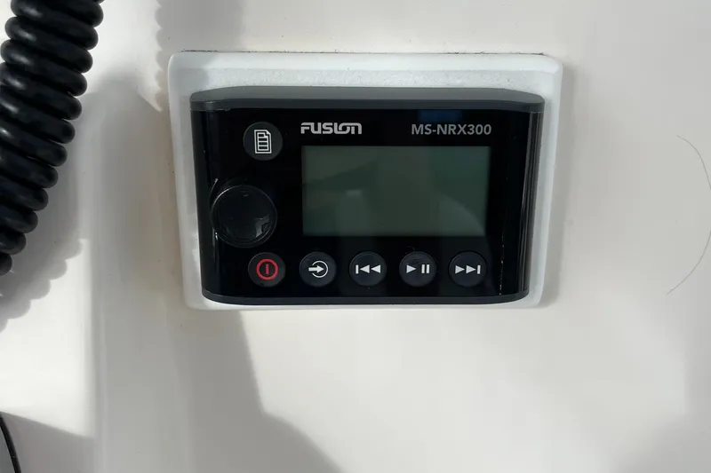 Slide: The Image of Fusion MS-NRX300 marine stereo controller on a 2012 Cobia 237CC boat dashboard. - 24