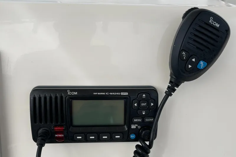 Slide: The Image of ICOM marine radio with microphone on a 2012 Cobia 237CC boat. - 26