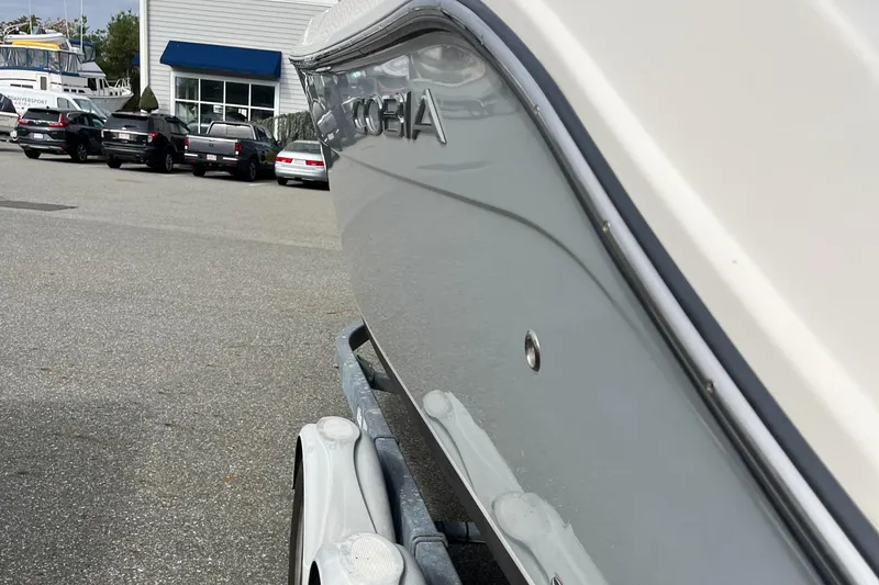 Slide: The Image of 2012 Cobia 237CC boat on trailer in parking lot. - 5