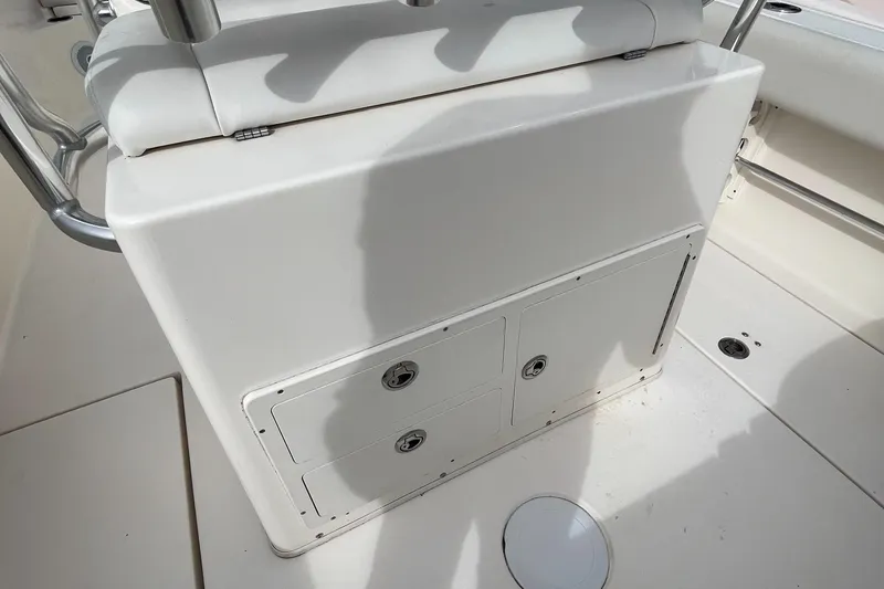 Slide: The Image of 2012 Cobia 237CC boat interior, featuring storage compartment and seating area. - 8