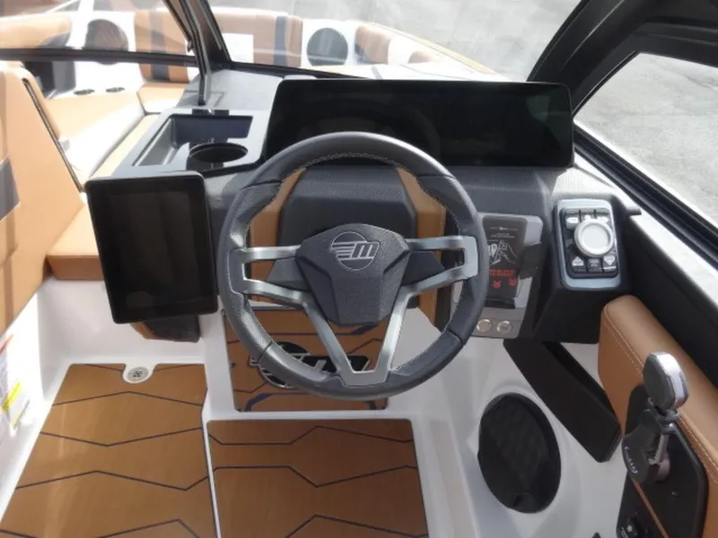 Slide: The Image of 2025 Malibu 24 MXZ boat dashboard with modern steering and controls. - 16