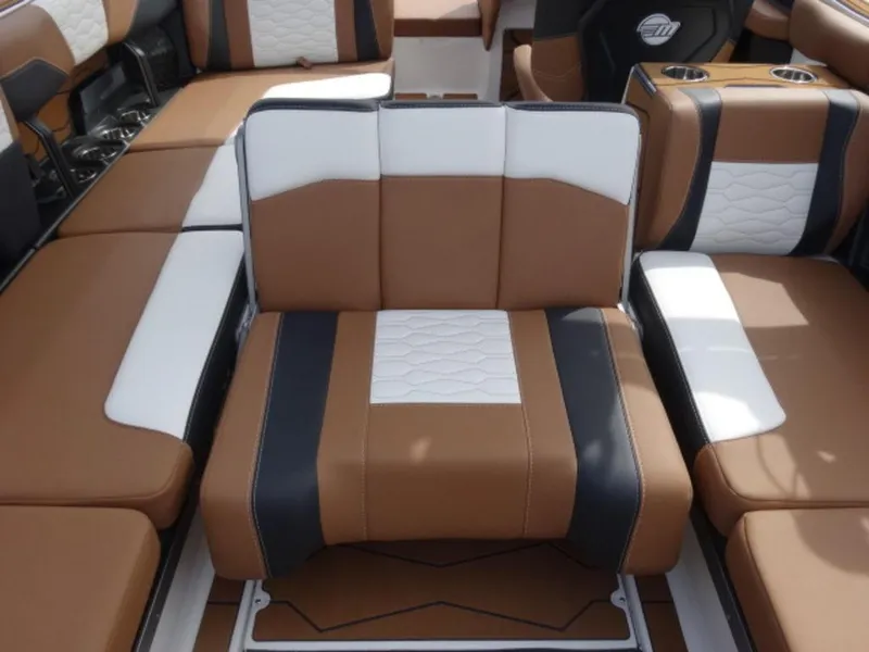 Slide: The Image of 2025 Malibu 24 MXZ boat interior with brown, black, and white seating. - 9