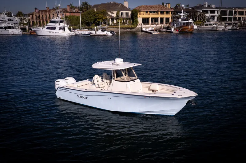 The Image of 2022 Grady-White 30.6 Canyon boat on calm water, with marina background. - 0